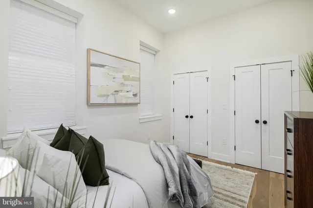 a bedroom with a bed and a painting on the wall