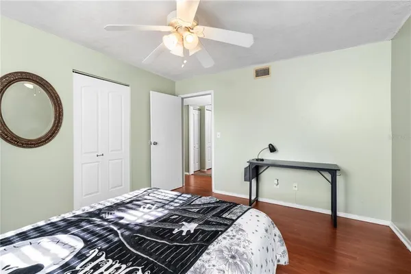 a bedroom with bed and a chandelier