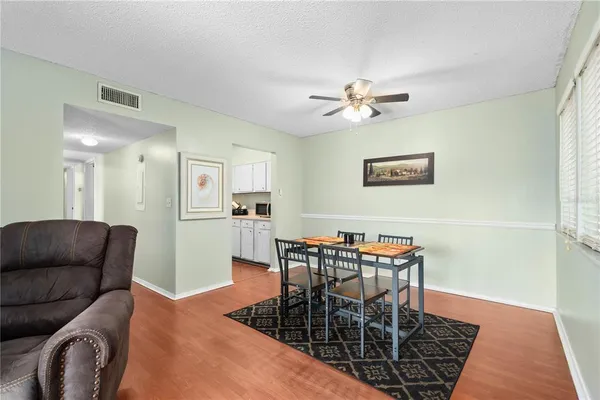 a view of a dining room with furniture and wooden floor