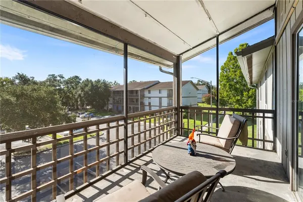 a view of a chairs and table in the balcony