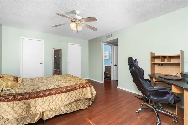 a bedroom with a bed and a desk