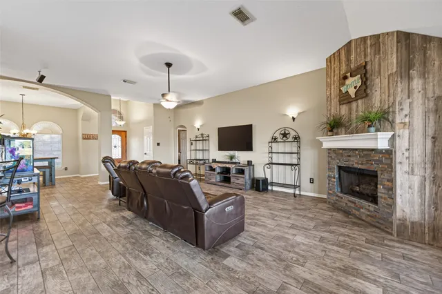 a living room with furniture a fireplace and a flat screen tv