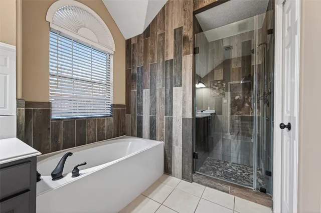 a bathroom with a bathtub and shower
