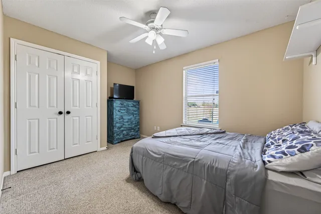 a bedroom with a bed closet and a window