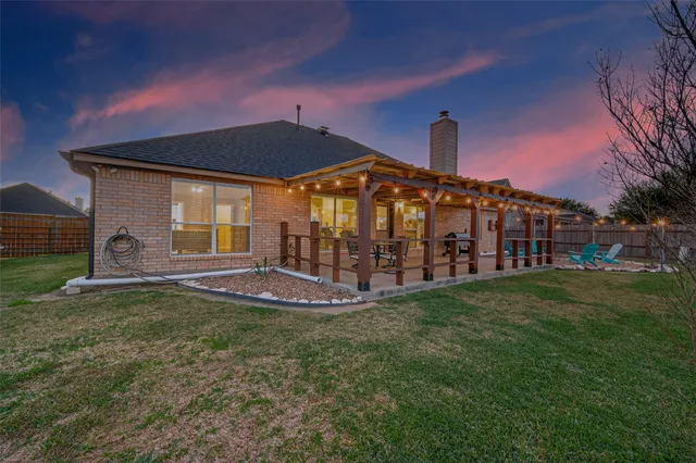 a view of a house with a yard and a porch