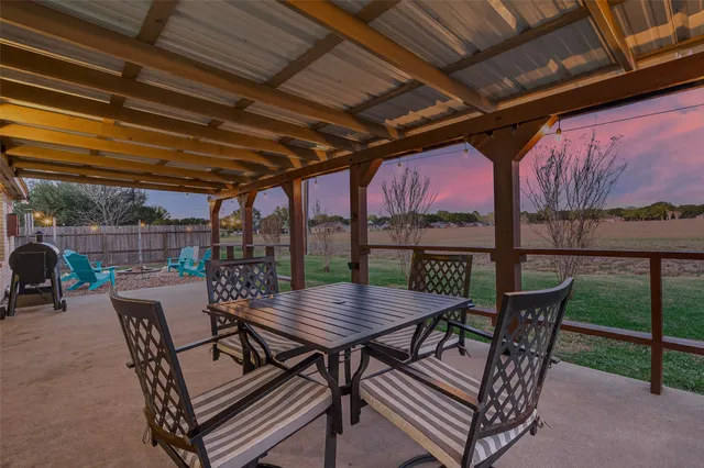 a view of a roof deck with a table and chairs