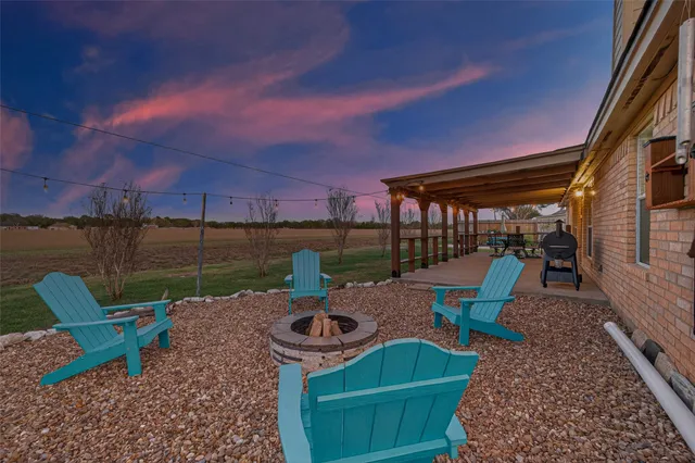 a view of a lake with a table and chairs