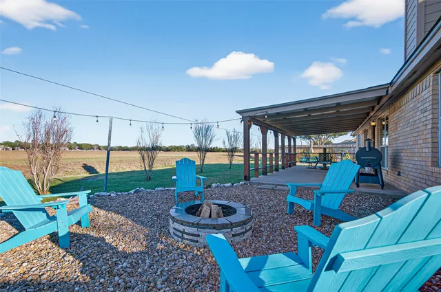 a view of a porch with chairs and backyard