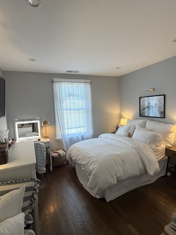 562 East 7th Street, Unit 2 Boston, MA 02127 - Photo 9 of 18 a bedroom with a bed and wooden floor
