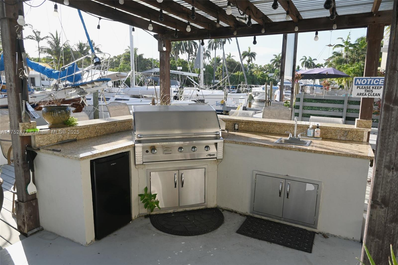317 Hendricks Isle, Unit 1 Fort Lauderdale, FL 33301 - Photo 14 of 15 a kitchen with a stove a sink and a wooden cabinets