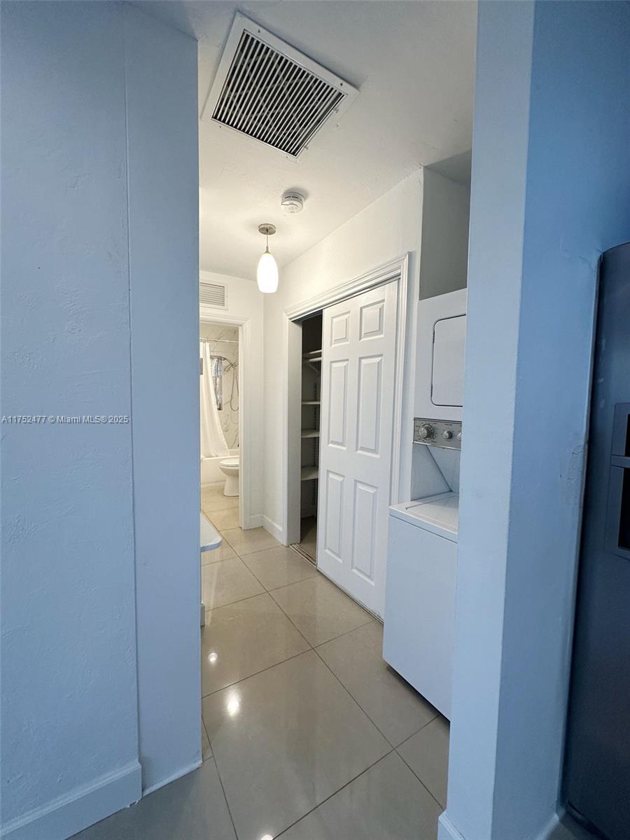 317 Hendricks Isle, Unit 1 Fort Lauderdale, FL 33301 - Photo 5 of 15 a view of a hallway with wooden cabinets