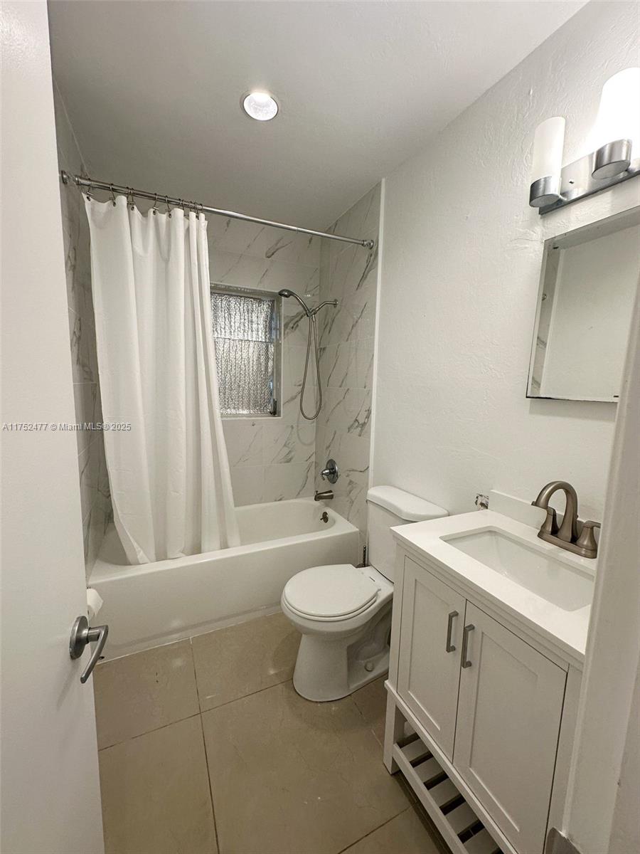 317 Hendricks Isle, Unit 1 Fort Lauderdale, FL 33301 - Photo 7 of 15 a bathroom with a sink toilet and shower