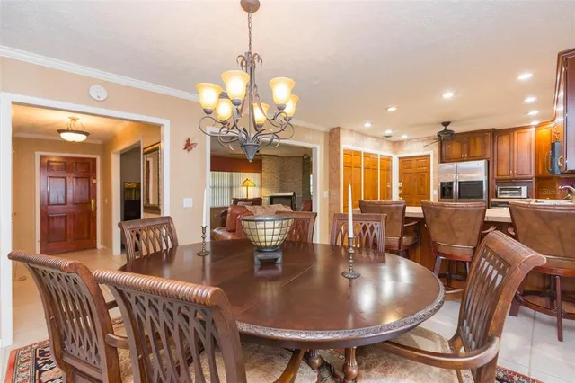 a view of a dining room with furniture a chandelier and wooden floor