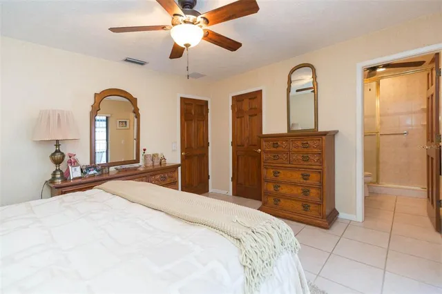 a bathroom with a granite countertop sink a toilet and a shower