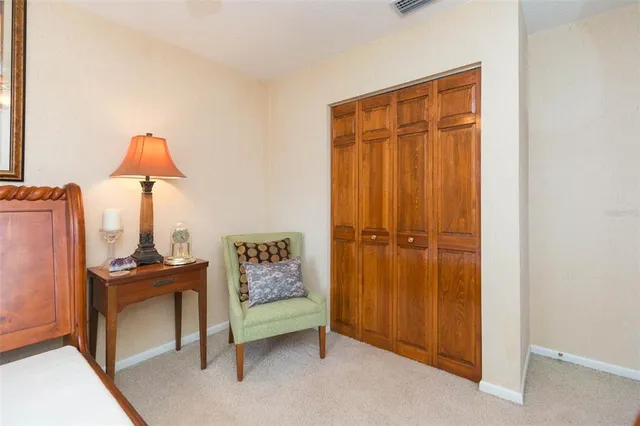 a view of room with flat screen tv and windows