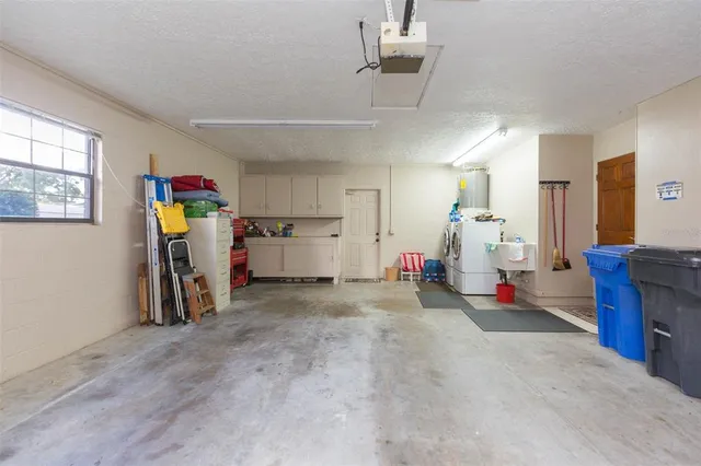 a dining room with furniture and a floor to ceiling window
