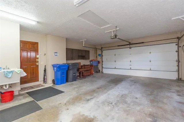 a view of a backyard with table and chairs under an umbrella