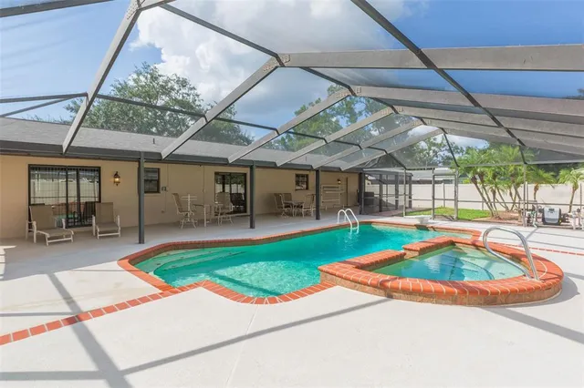 a view of a house with a yard patio and fire pit