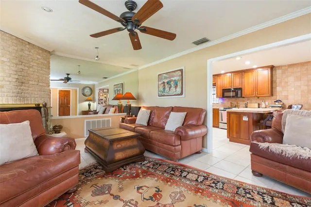 a living room with furniture ceiling fan and a rug