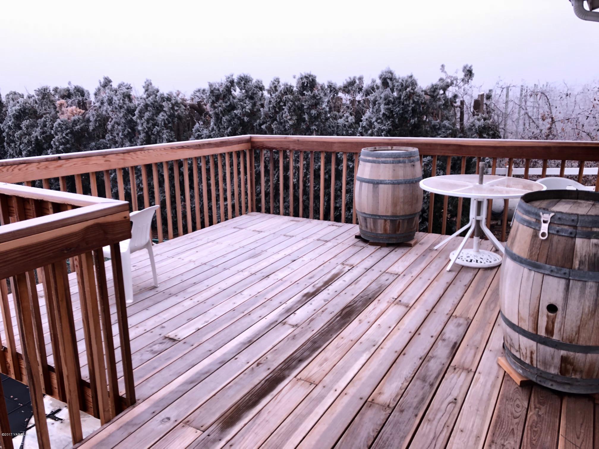 139601 Mccredie Road West Prosser, WA 99350 - Photo 22 of 55 a balcony with wooden floor outdoor seating and yard in the back