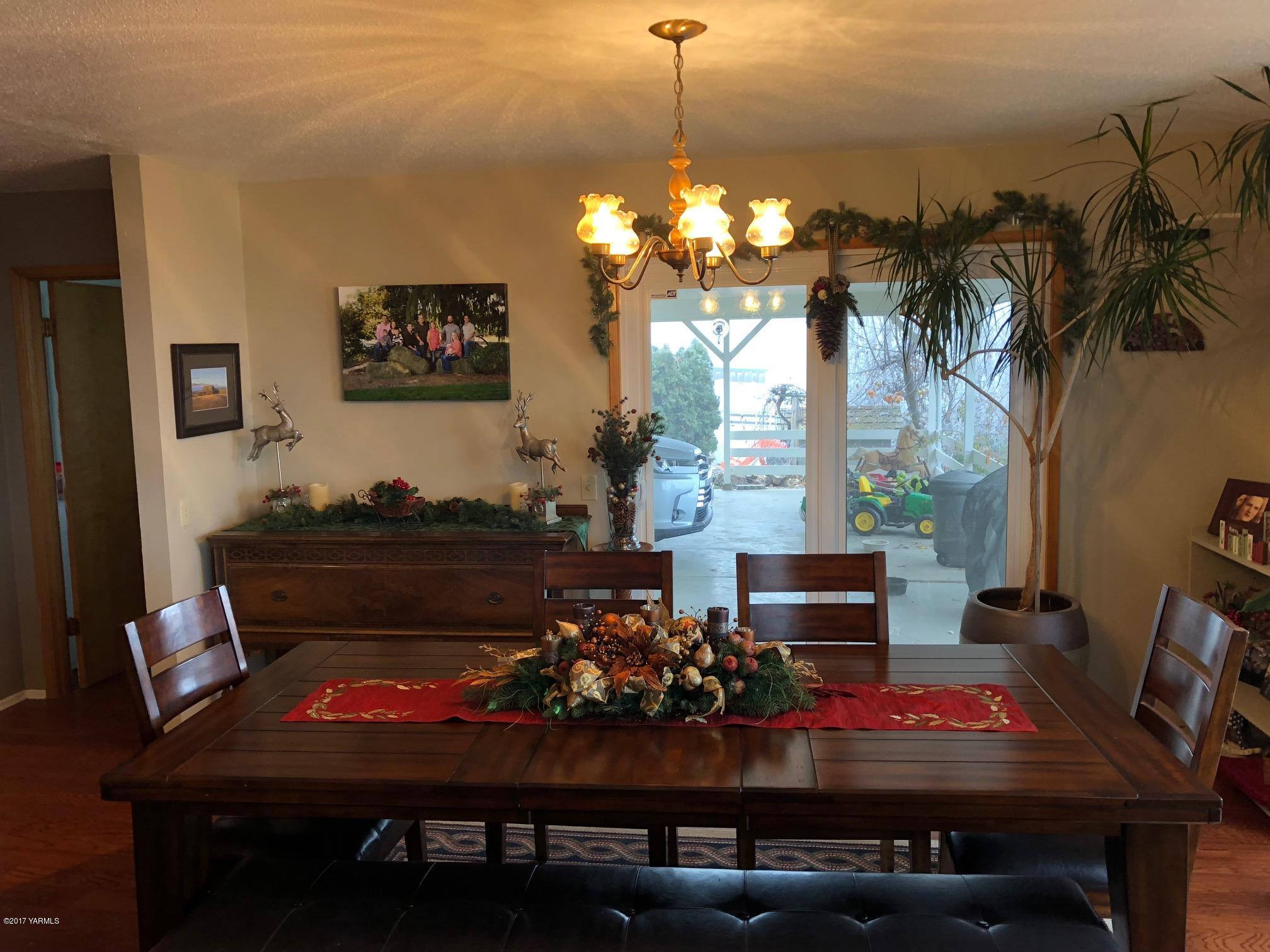 139601 Mccredie Road West Prosser, WA 99350 - Photo 35 of 55 a view of a dining room with furniture a chandelier and wooden floor