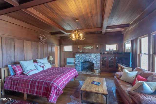 a bedroom with a bed and a television