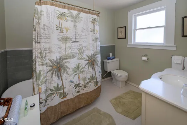 a view of a porch with chairs and potted plants
