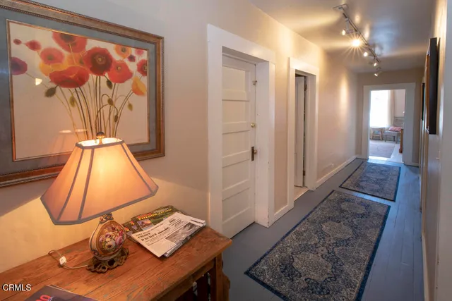 a view of a house with a patio and a yard