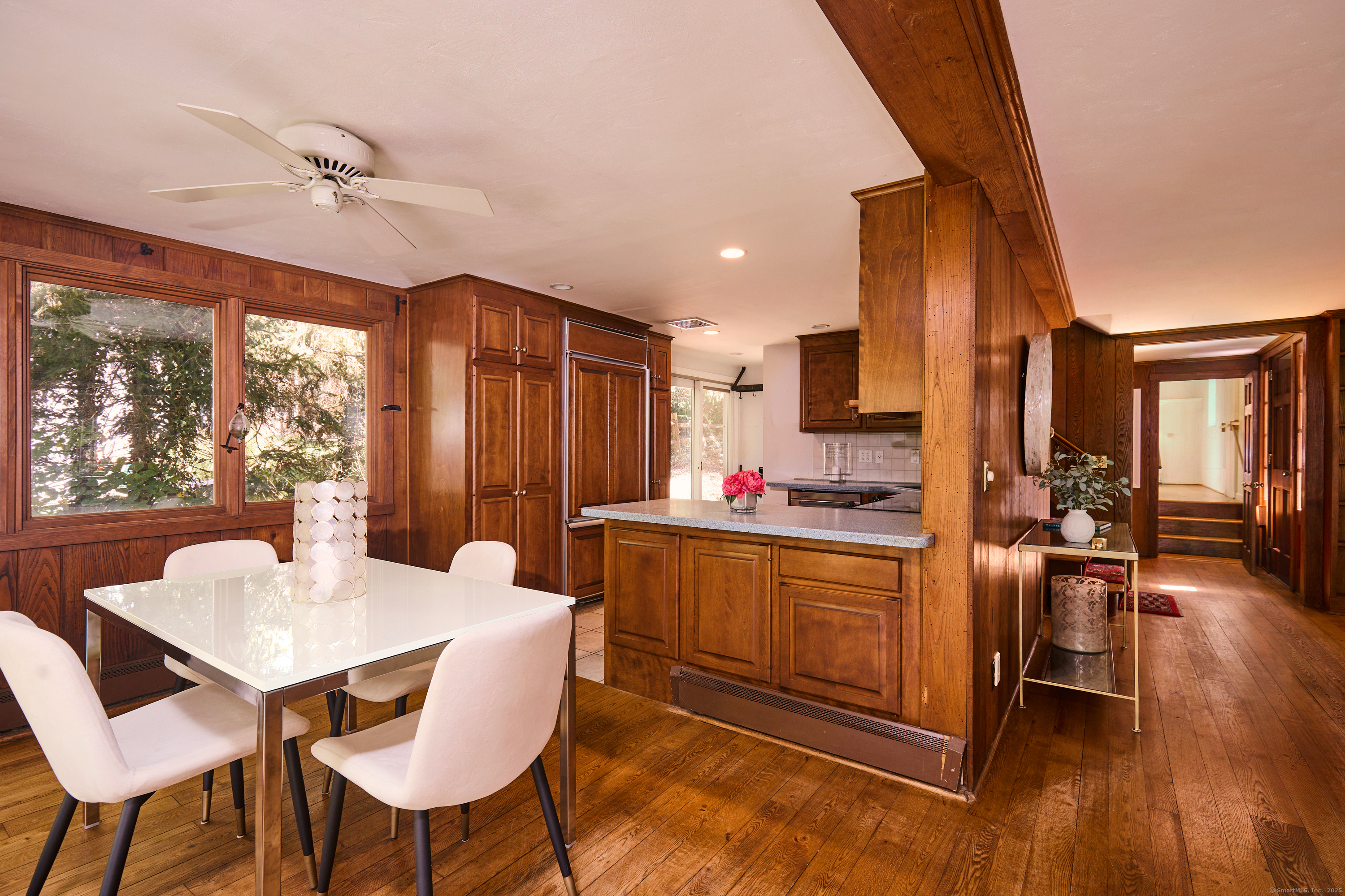 136 Lyons Plain Road Weston, CT 06883 - Photo 14 of 31 a kitchen with stainless steel appliances kitchen island granite countertop a table chairs and a refrigerator