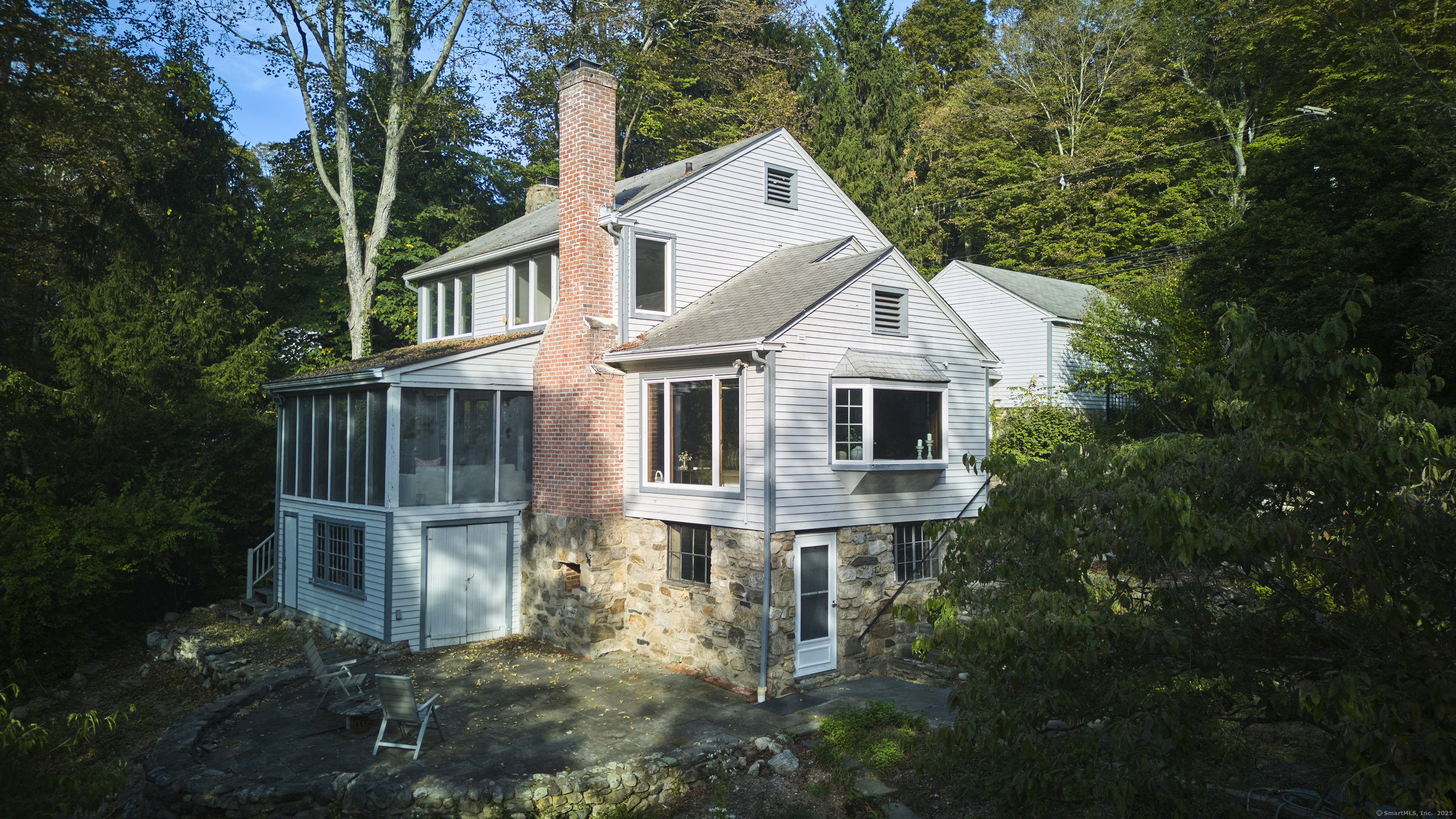 136 Lyons Plain Road Weston, CT 06883 - Photo 15 of 31 a front view of a house with plants and garden