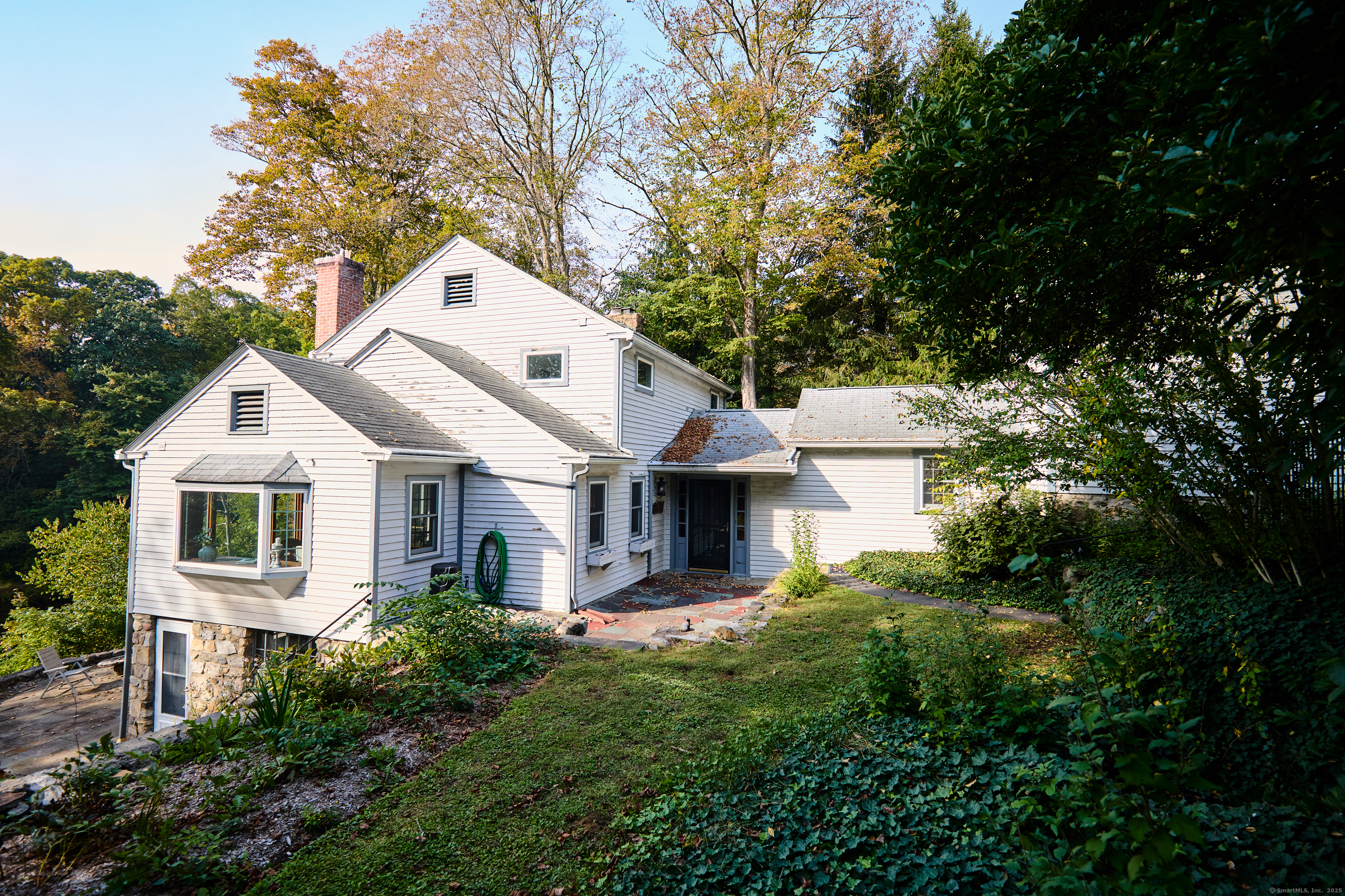 136 Lyons Plain Road Weston, CT 06883 - Photo 16 of 31 a front view of house with yard and green space