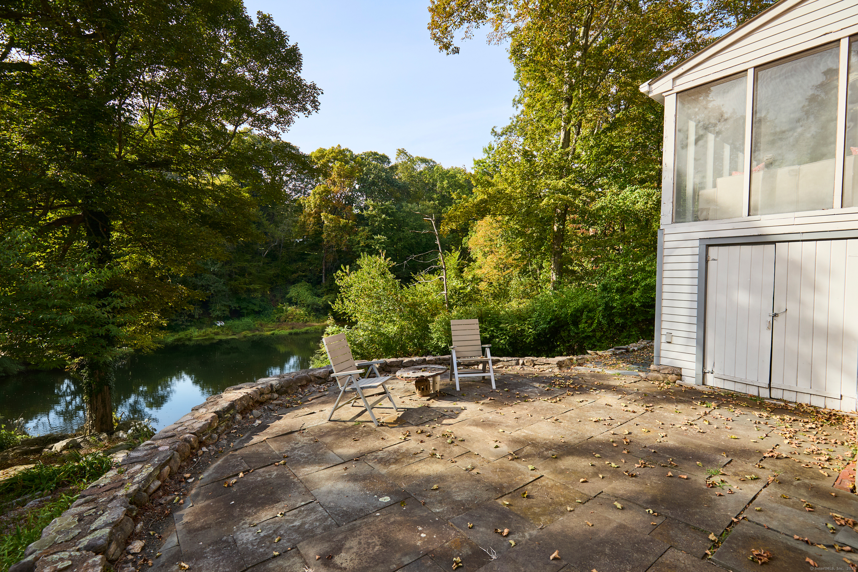 136 Lyons Plain Road Weston, CT 06883 - Photo 18 of 31 a backyard of a house with lots of green space