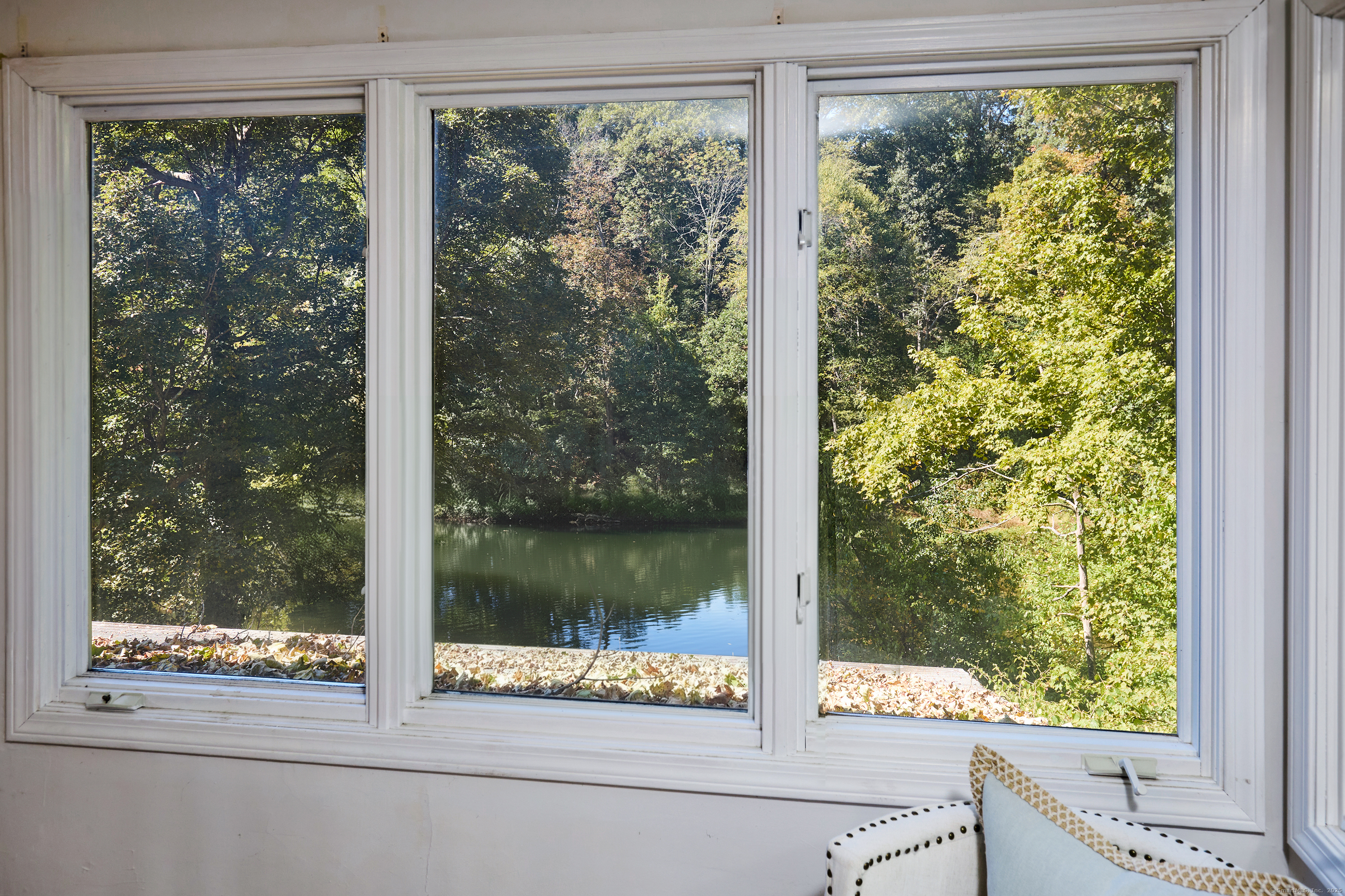 136 Lyons Plain Road Weston, CT 06883 - Photo 22 of 31 a view of a room that has a bed and a window