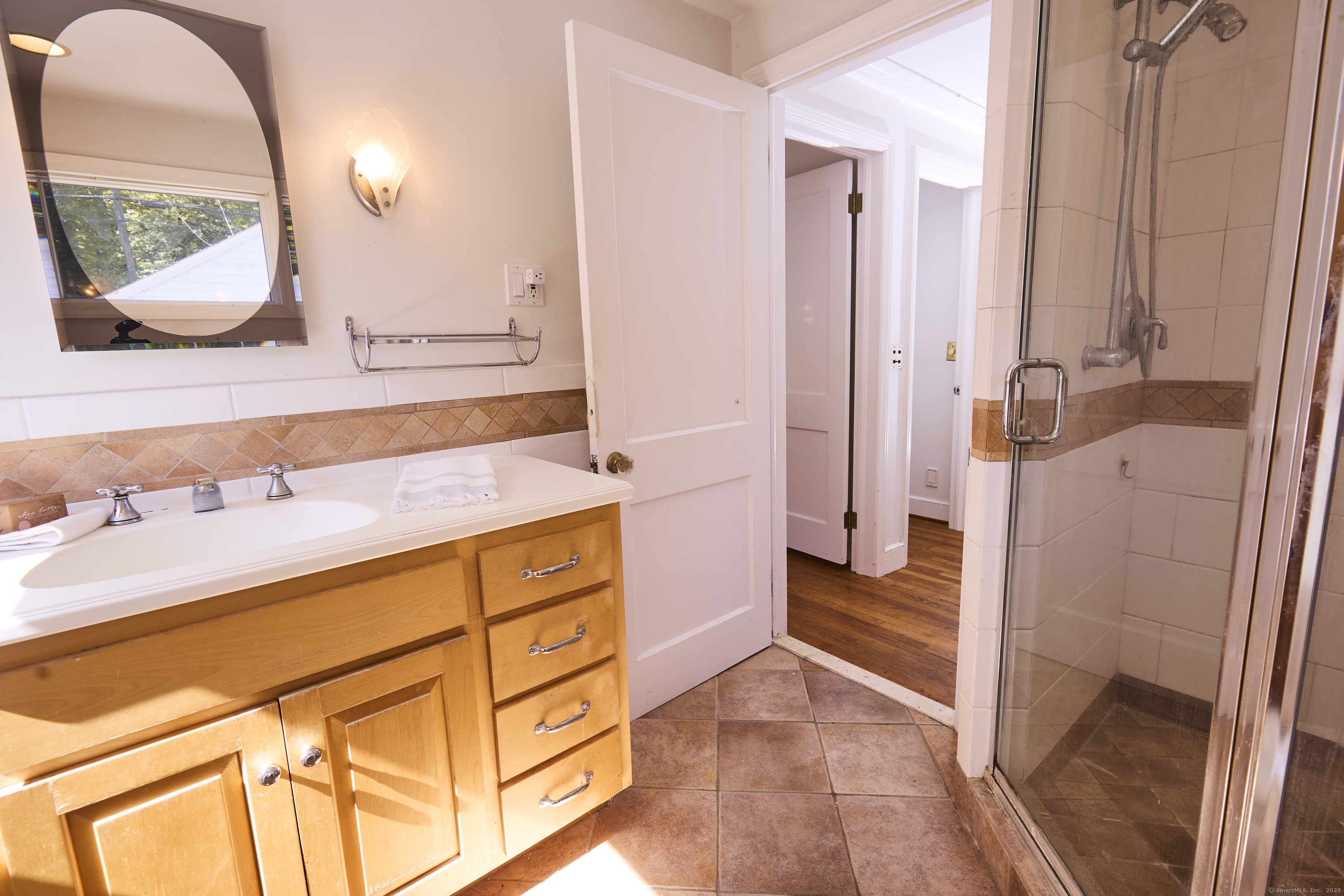 136 Lyons Plain Road Weston, CT 06883 - Photo 25 of 31 a bathroom with a sink and a mirror
