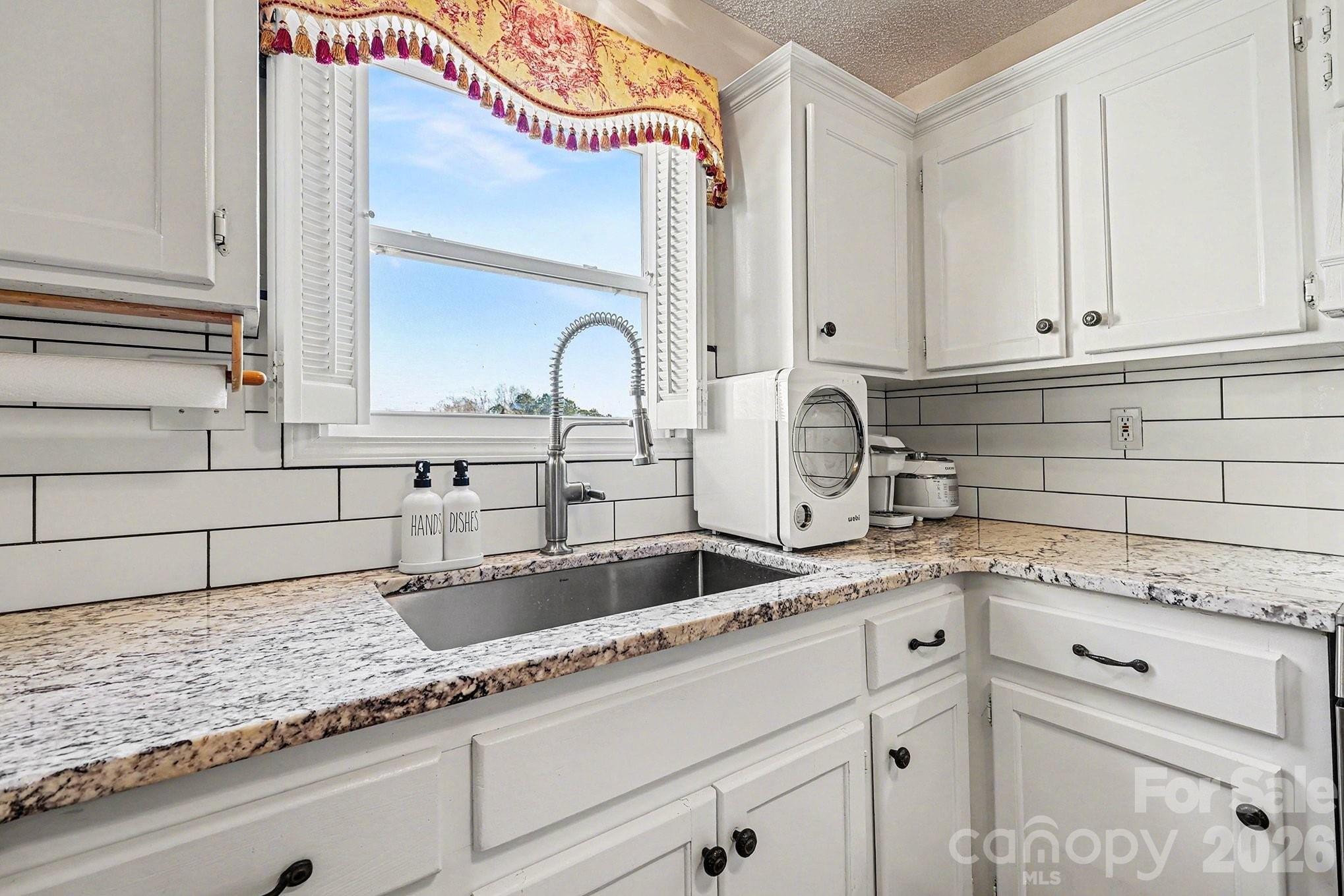 205 John Cline Road Cherryville, NC 28021 - Photo 12 of 41 a kitchen with granite countertop a sink and cabinets