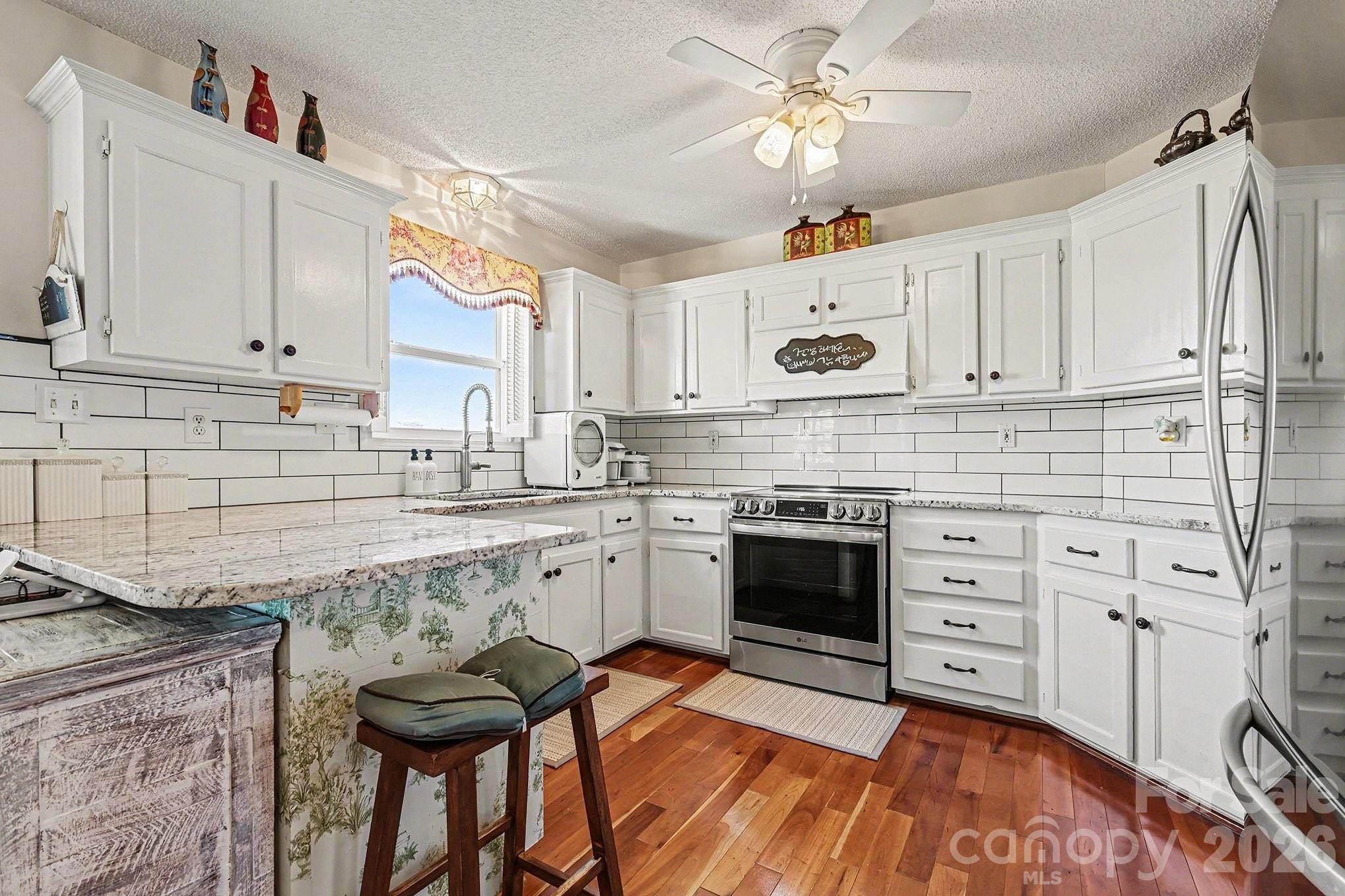 205 John Cline Road Cherryville, NC 28021 - Photo 9 of 41 a kitchen with stainless steel appliances granite countertop a stove and white cabinets