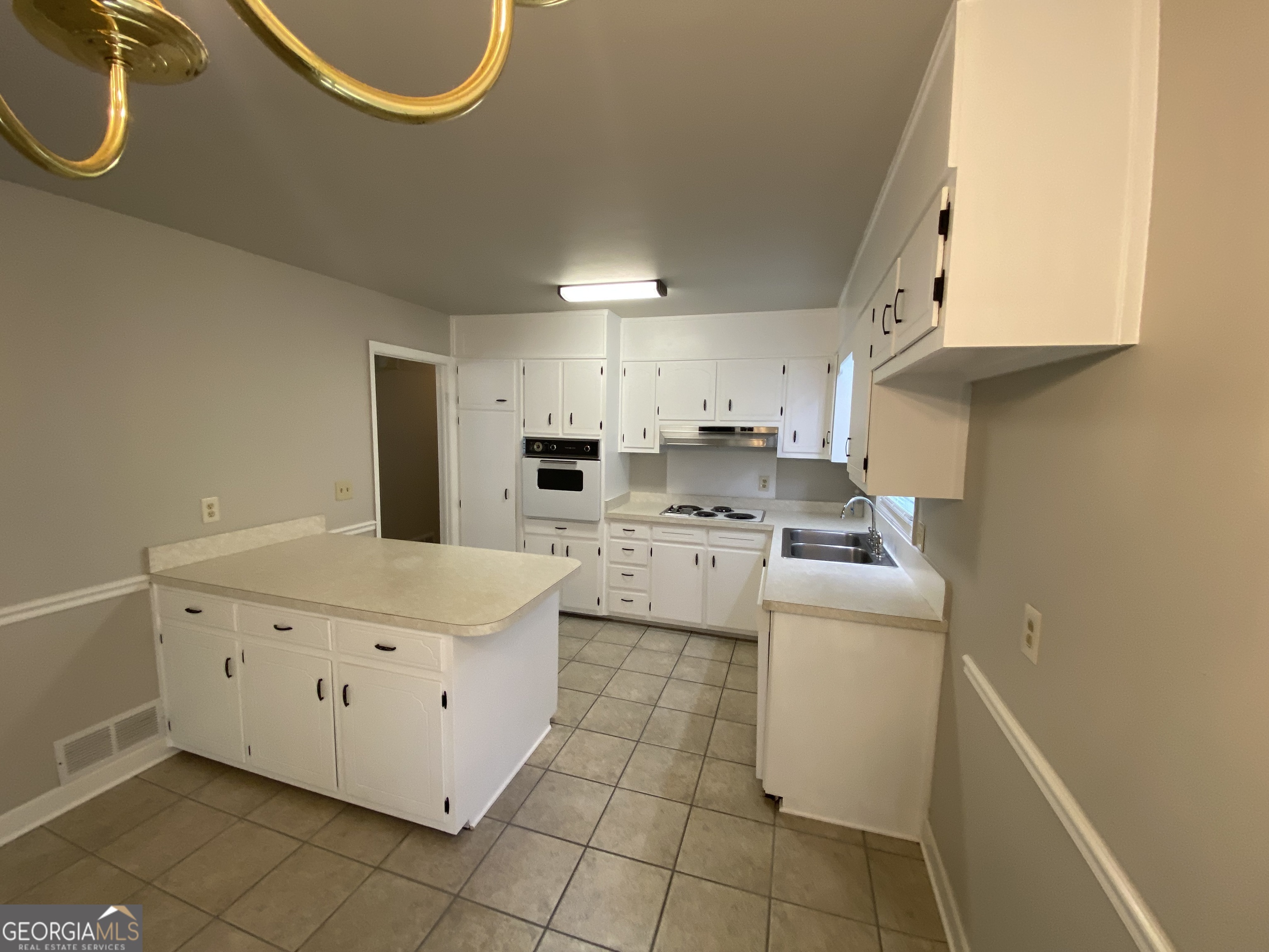 6092 Prestige Valley Road Morrow, GA 30260 - Photo 3 of 11 a kitchen with a sink a stove top oven and cabinets