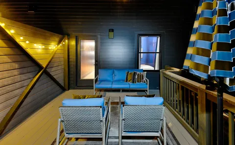 a view of a room with furniture and wooden floor