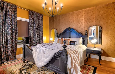 a bedroom with a bed and wooden cabinets