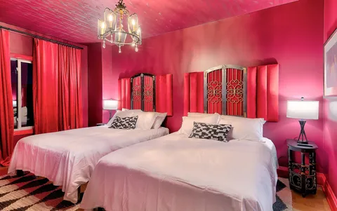 a bedroom with a bed and a chandelier