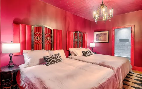 a bedroom with a bed and a chandelier