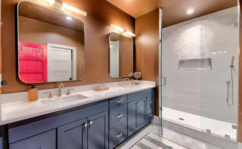 a bathroom with a double vanity sink and a mirror