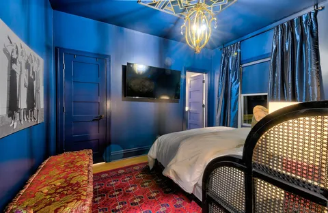 a bedroom with bed and a chandelier