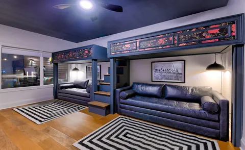 a living room with furniture a rug and a flat screen tv