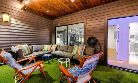 a outdoor living space with furniture and a rug