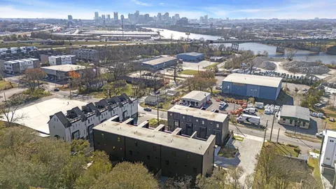a view of a house with pool and wooden fence