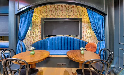 a blue table sitting next to a window