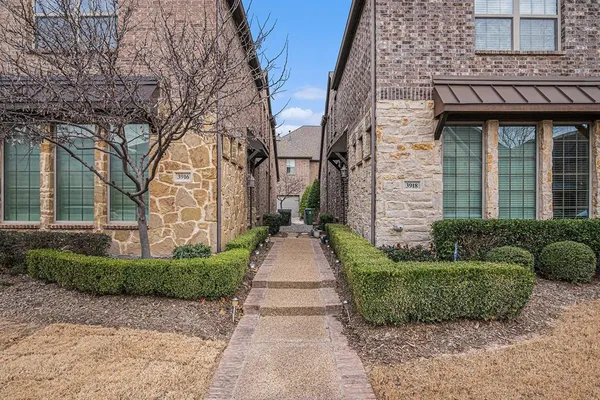 front view of a brick house with a yard