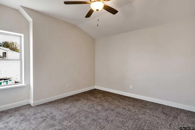 an empty room with a empty space and a ceiling fan