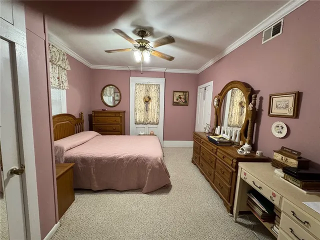 a bedroom with a bed chair and dresser